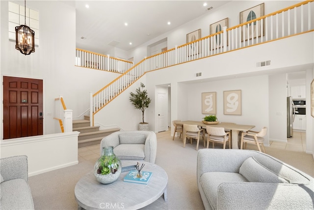 19139 Chandon Ln, Huntington Beach, CA 92648 - living room with a high ceiling, stairway, light colored carpet, recessed lighting, and baseboards