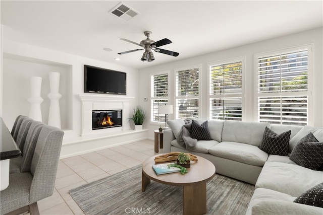19139 Chandon Ln, Huntington Beach, CA 92648 - tiled living room with a ceiling fan, a glass covered fireplace, and baseboards