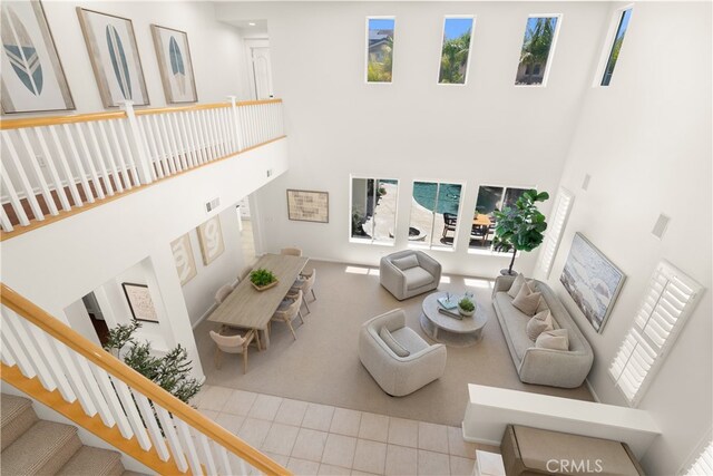 19139 Chandon Ln, Huntington Beach, CA 92648 - tiled living area featuring a towering ceiling and stairs