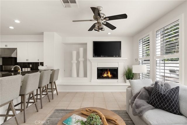 19139 Chandon Ln, Huntington Beach, CA 92648 - living room with ceiling fan, recessed lighting, a glass covered fireplace, and light tile patterned flooring