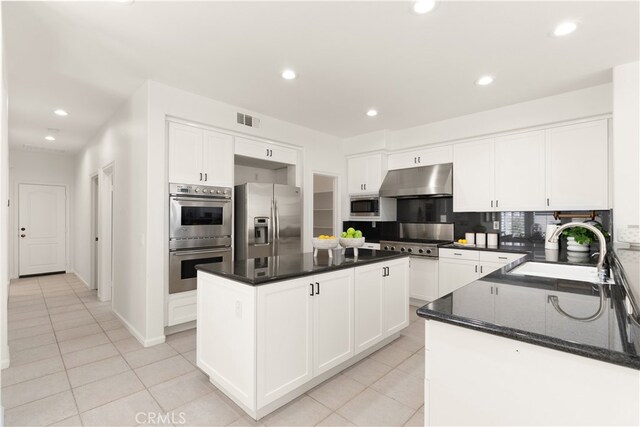 19139 Chandon Ln, Huntington Beach, CA 92648 - kitchen featuring appliances with stainless steel finishes, a sink, under cabinet range hood, light tile patterned floors, and recessed lighting