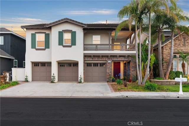 19139 Chandon Ln, Huntington Beach, CA 92648 - view of front of home with stucco siding, concrete driveway, a garage, and a balcony
