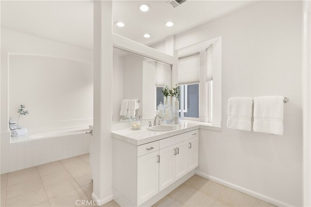 19139 Chandon Ln, Huntington Beach, CA 92648 - bathroom with vanity, a garden tub, tile patterned flooring, recessed lighting, and baseboards