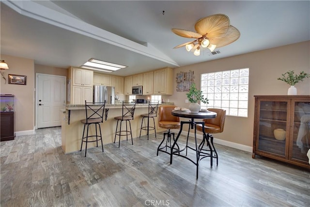 1121 Rose Ct, Grover Beach, CA 93433 - dining area with baseboards, light wood-style flooring, lofted ceiling, and ceiling fan