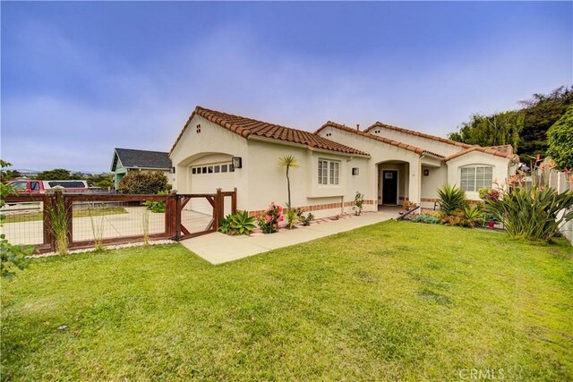 1121 Rose Ct, Grover Beach, CA 93433 - mediterranean / spanish-style home featuring an attached garage, stucco siding, and a tile roof