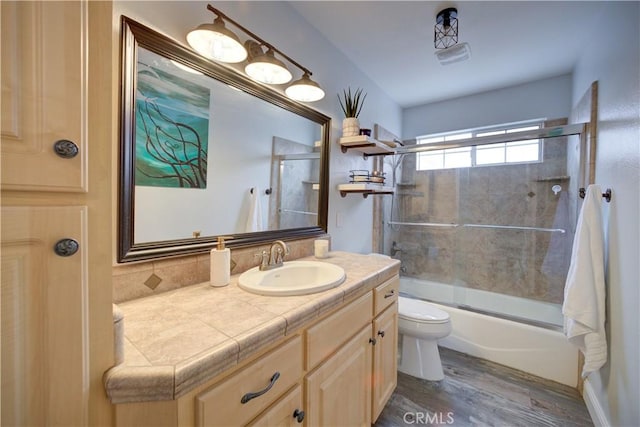 1121 Rose Ct, Grover Beach, CA 93433 - full bath with toilet, vanity, wood finished floors, and bath / shower combo with glass door