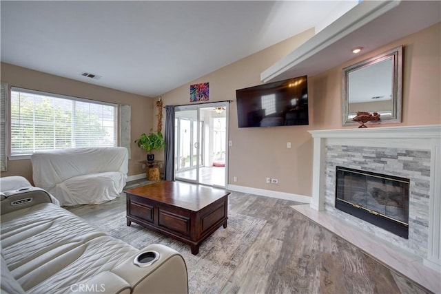 1121 Rose Ct, Grover Beach, CA 93433 - living area with vaulted ceiling, light wood finished floors, a fireplace, and baseboards