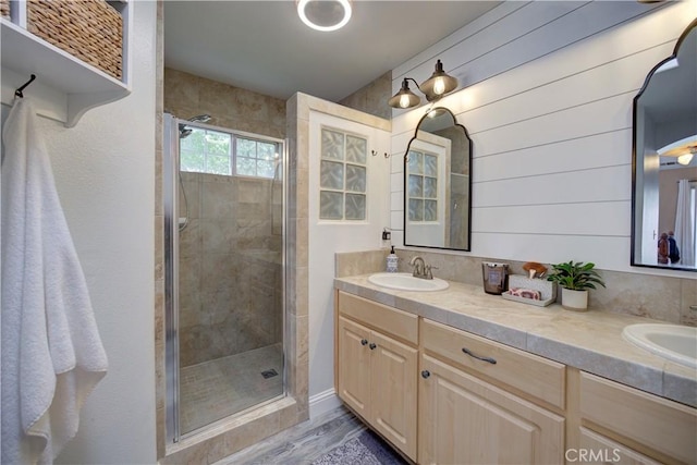 1121 Rose Ct, Grover Beach, CA 93433 - full bathroom with a shower stall, double vanity, and wood finished floors