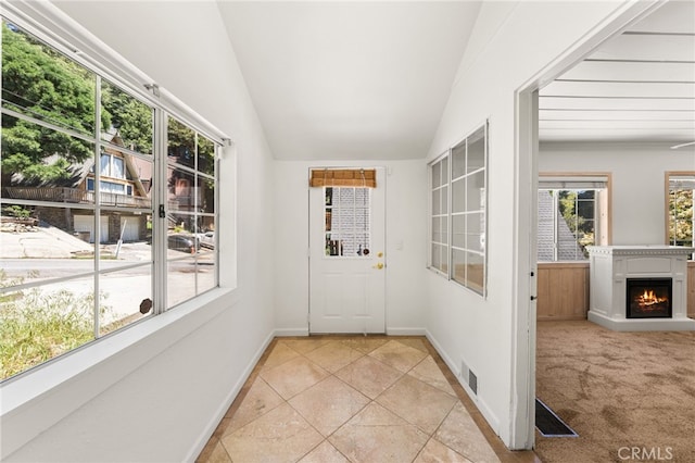 1244 Bear Springs Rd, Twin Peaks, CA 92391 - doorway featuring light tile patterned floors, vaulted ceiling, a warm lit fireplace, and baseboards