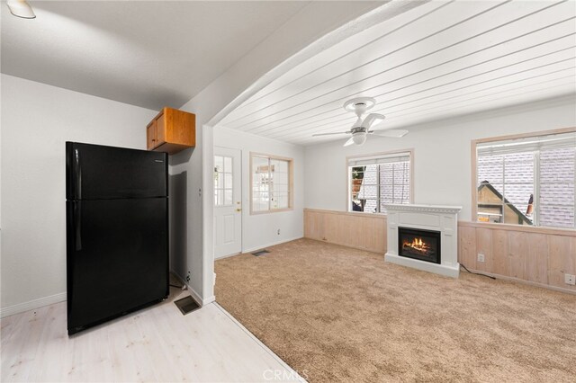 1244 Bear Springs Rd, Twin Peaks, CA 92391 - kitchen featuring freestanding refrigerator, a ceiling fan, wainscoting, a glass covered fireplace, and light wood-type flooring