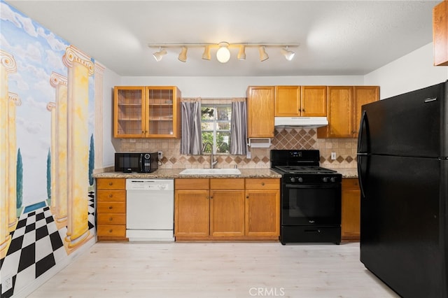 1244 Bear Springs Rd, Twin Peaks, CA 92391 - kitchen with black appliances, under cabinet range hood, a sink, decorative backsplash, and brown cabinets