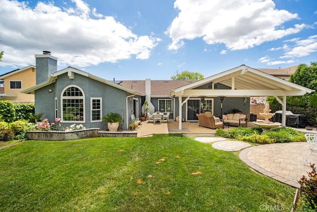 6505 Smoke Tree Ave, Oak Park, CA 91377 - rear view of property featuring an outdoor living space, a patio, a lawn, and a chimney