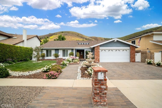 6505 Smoke Tree Ave, Oak Park, CA 91377 - single story home with driveway, a mountain view, and an attached garage