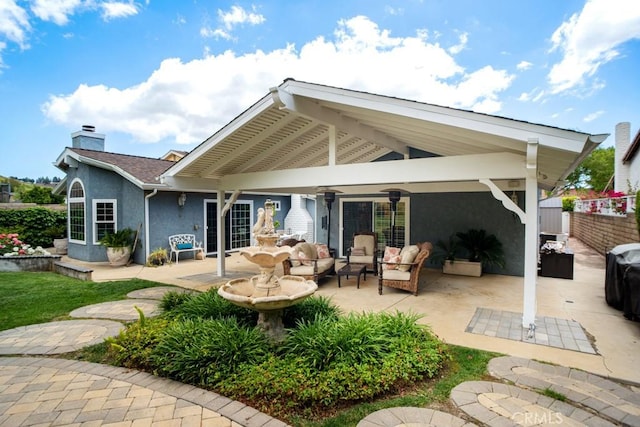 6505 Smoke Tree Ave, Oak Park, CA 91377 - rear view of property with stucco siding, a patio area, a chimney, and an outdoor living space