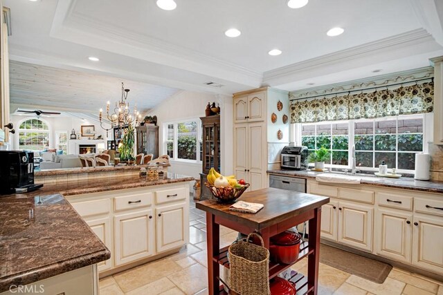 6505 Smoke Tree Ave, Oak Park, CA 91377 - kitchen featuring cream cabinetry, healthy amount of natural light, recessed lighting, stone tile floors, and dishwasher