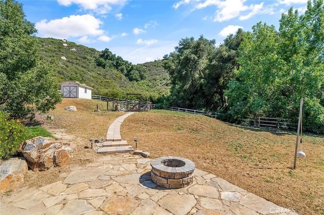 41275 Hacienda Dr, Murrieta, CA 92562 - view of yard featuring a fire pit, a patio, a wooded view, and a mountain view