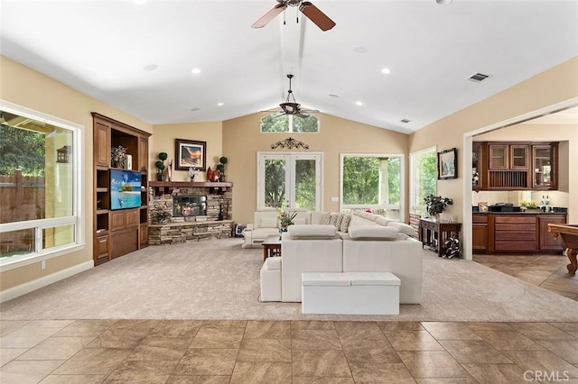 41275 Hacienda Dr, Murrieta, CA 92562 - living area featuring ceiling fan, a fireplace, vaulted ceiling, baseboards, and light stone finish floors