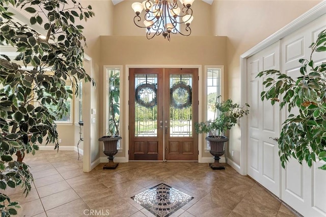 41275 Hacienda Dr, Murrieta, CA 92562 - tiled entryway featuring french doors, a chandelier, a high ceiling, and baseboards
