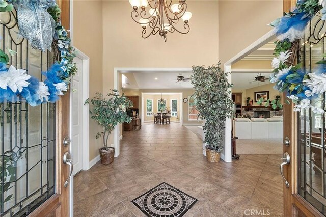 41275 Hacienda Dr, Murrieta, CA 92562 - entryway featuring a high ceiling, a chandelier, a ceiling fan, and baseboards