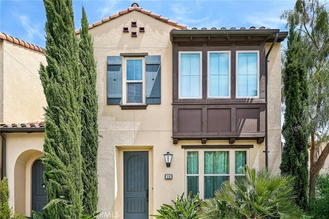 114 Desert Lotus, Irvine, CA 92618 - view of front of house with stucco siding and a tile roof