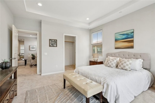 114 Desert Lotus, Irvine, CA 92618 - bedroom featuring light carpet, recessed lighting, a raised ceiling, a walk in closet, and baseboards