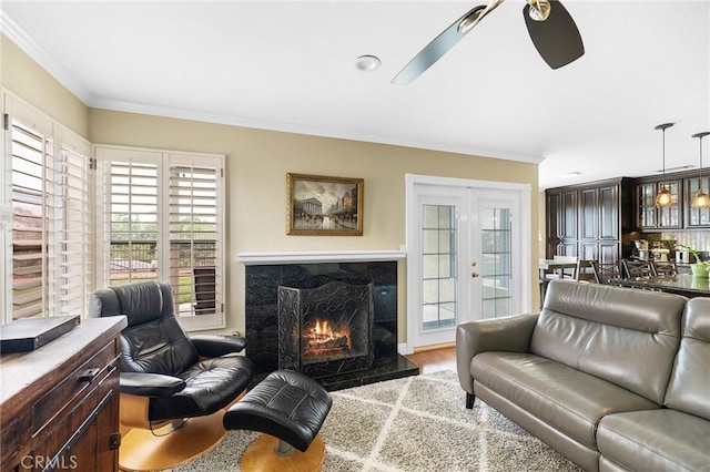 40678 Alondra Dr, Murrieta, CA 92562 - living area featuring crown molding, a premium fireplace, a ceiling fan, and wood finished floors