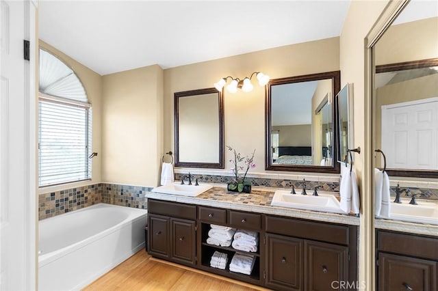 40678 Alondra Dr, Murrieta, CA 92562 - bathroom with double vanity, a bath, and wood finished floors