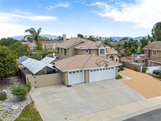 40678 Alondra Dr, Murrieta, CA 92562 - view of front of house with a tiled roof, driveway, an attached garage, a gate, and a mountain view