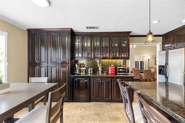 40678 Alondra Dr, Murrieta, CA 92562 - kitchen with beverage cooler, refrigerator with ice dispenser, decorative backsplash, dark brown cabinets, and glass insert cabinets