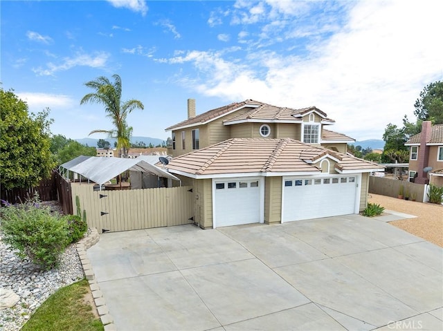 40678 Alondra Dr, Murrieta, CA 92562 - traditional home with concrete driveway, a tiled roof, a chimney, and a gate