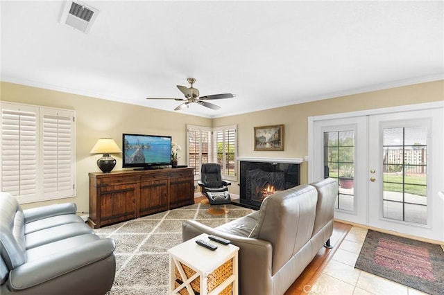 40678 Alondra Dr, Murrieta, CA 92562 - living room with french doors, ornamental molding, ceiling fan, a fireplace, and light tile patterned floors