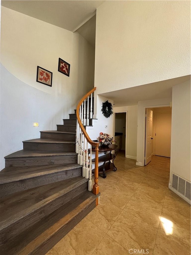 21265 E Fort Bowie Dr, Walnut, CA 91789 - staircase with a high ceiling, tile patterned flooring, and baseboards