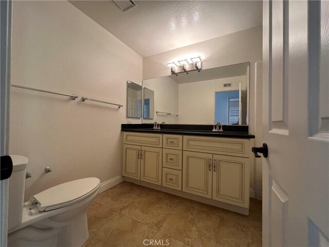 21265 E Fort Bowie Dr, Walnut, CA 91789 - bathroom featuring double vanity, toilet, tile patterned flooring, and baseboards