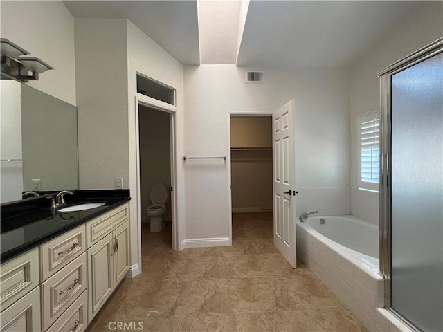 21265 E Fort Bowie Dr, Walnut, CA 91789 - full bathroom featuring toilet, vanity, a garden tub, and a walk in closet