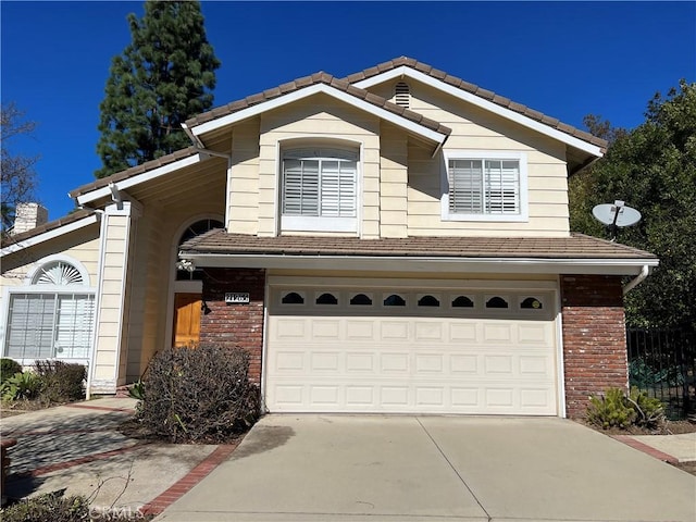 21265 E Fort Bowie Dr, Walnut, CA 91789 - view of front facade featuring an attached garage, driveway, brick siding, and a tile roof