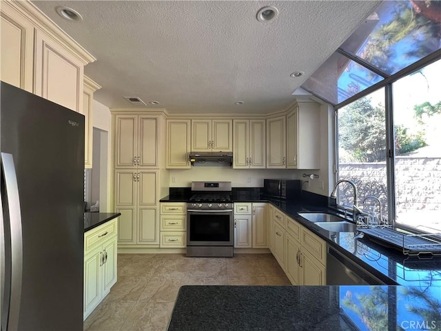 21265 E Fort Bowie Dr, Walnut, CA 91789 - kitchen featuring appliances with stainless steel finishes, cream cabinets, a sink, extractor fan, and a textured ceiling