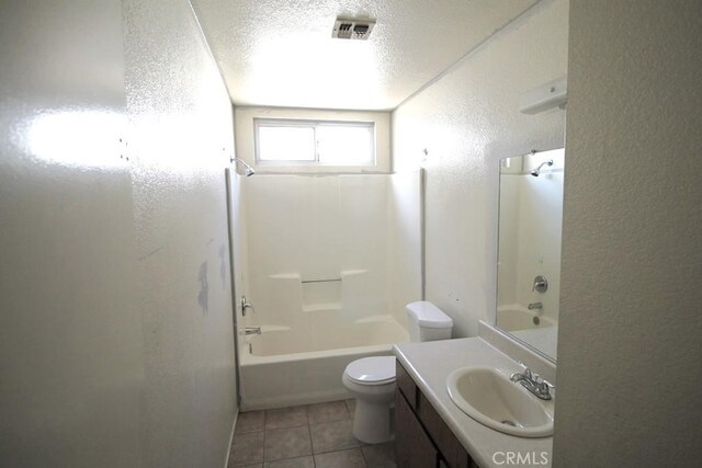 751 Higgins Rd Unit 10, Barstow, CA 92311 - bathroom featuring a textured wall, vanity, shower / tub combination, tile patterned floors, and toilet