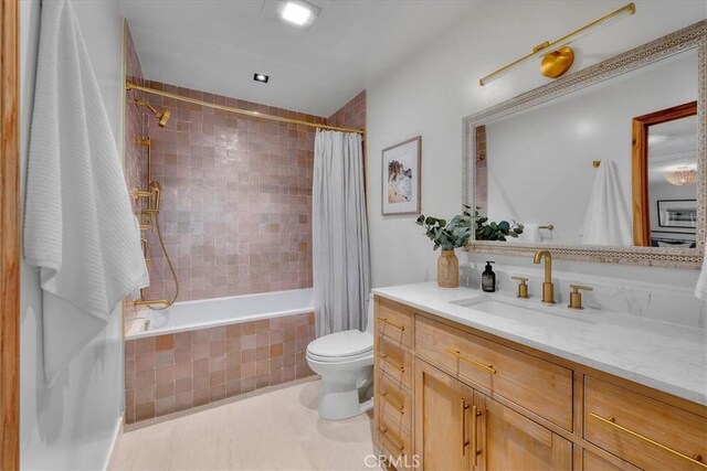 1330 8th St, Manhattan Beach, CA 90266 - bathroom featuring tiled shower / bath, vanity, toilet, and tile patterned flooring
