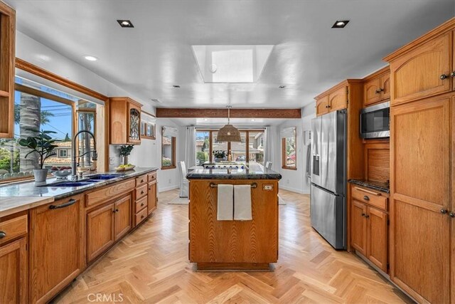 1330 8th St, Manhattan Beach, CA 90266 - kitchen featuring appliances with stainless steel finishes, a sink, a center island, brown cabinetry, and recessed lighting