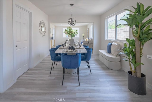 14609 Clark St, Baldwin Park, CA 91706 - dining area with plenty of natural light, light wood finished floors, baseboards, and a chandelier