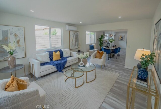 14609 Clark St, Baldwin Park, CA 91706 - living room with a wall mounted AC, wood finished floors, recessed lighting, and baseboards