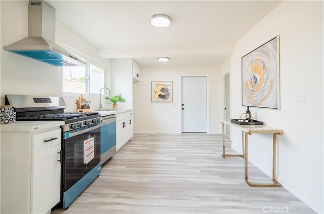 14609 Clark St, Baldwin Park, CA 91706 - kitchen with gas range, dishwasher, wall chimney exhaust hood, a sink, and white cabinets