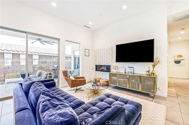 52300 Avenida Velasco Ln, Quinta, CA 92253 - tiled living room with recessed lighting, ceiling fan, a glass covered fireplace, and baseboards