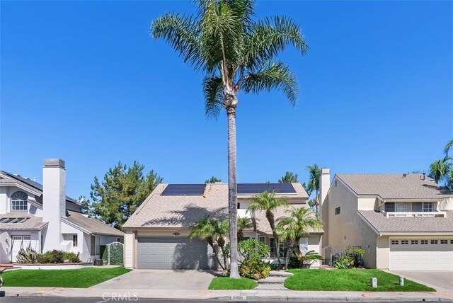 21321 Spruce, Mission Viejo, CA 92692 - view of front of property featuring driveway, an attached garage, solar panels, and a front lawn
