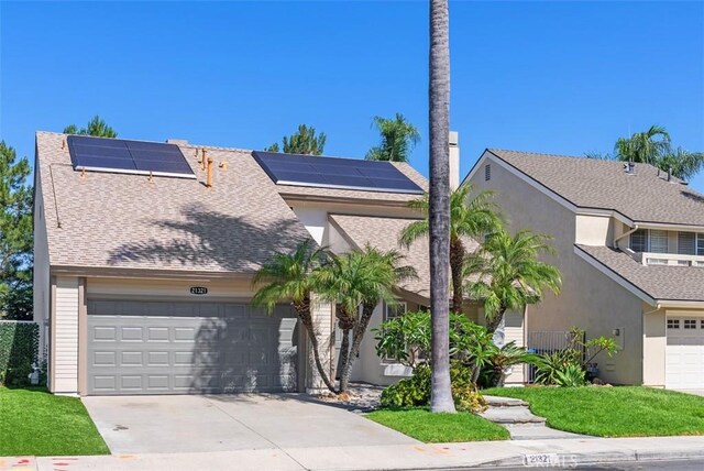 21321 Spruce, Mission Viejo, CA 92692 - view of front of house with an attached garage, stucco siding, concrete driveway, and roof mounted solar panels
