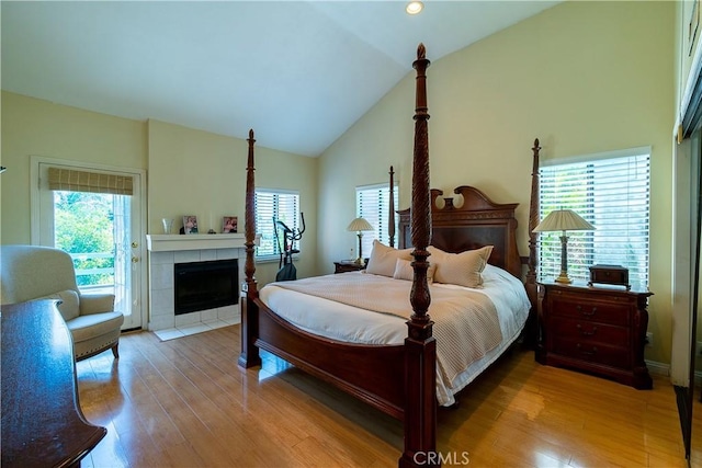 18759 Hatteras St Unit 25, Tarzana, CA 91356 - bedroom with wood finished floors, access to exterior, a tile fireplace, and high vaulted ceiling