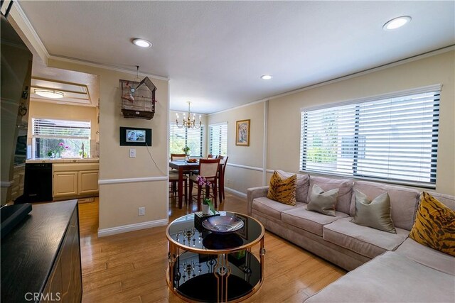 18759 Hatteras St Unit 25, Tarzana, CA 91356 - living room with crown molding, light wood-style floors, a chandelier, baseboards, and recessed lighting
