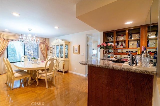 18759 Hatteras St Unit 25, Tarzana, CA 91356 - dining room featuring light wood finished floors, a chandelier, baseboards, and recessed lighting
