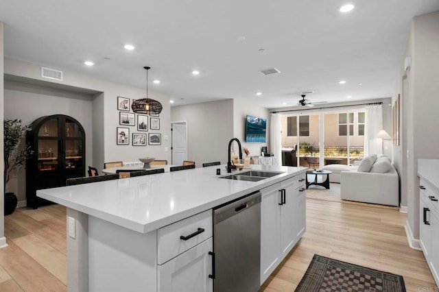 7902 Belluno Way, San Diego, CA 92126 - kitchen with stainless steel dishwasher, a sink, a center island with sink, open floor plan, and a ceiling fan
