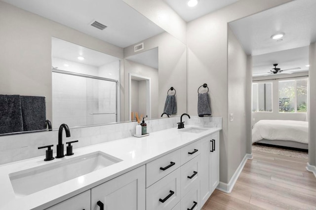 7902 Belluno Way, San Diego, CA 92126 - full bathroom with double vanity, wood finished floors, a shower stall, a ceiling fan, and recessed lighting